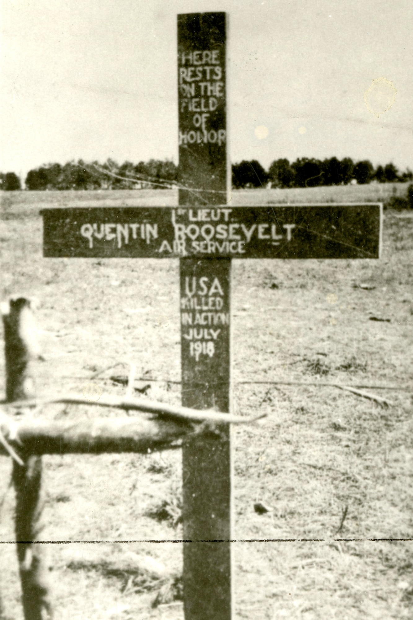 Cross placed on Roosevelt's grave by U.S. troops.  Original German cross appears in the left foreground. (U.S. Air Force photo)     