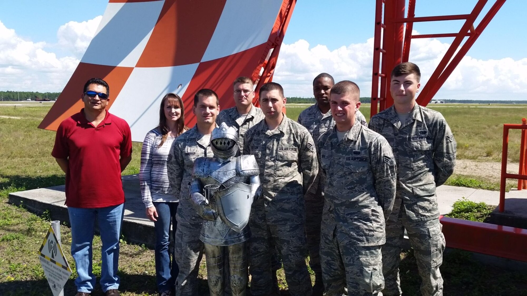 The 325th Operation Support Squadron, Air Traffic Control and Landing Systems Maintenance Flight stands on the Tyndall flight line next to a piece of equipment they maintain. (U.S. Air Force courtesy photo)