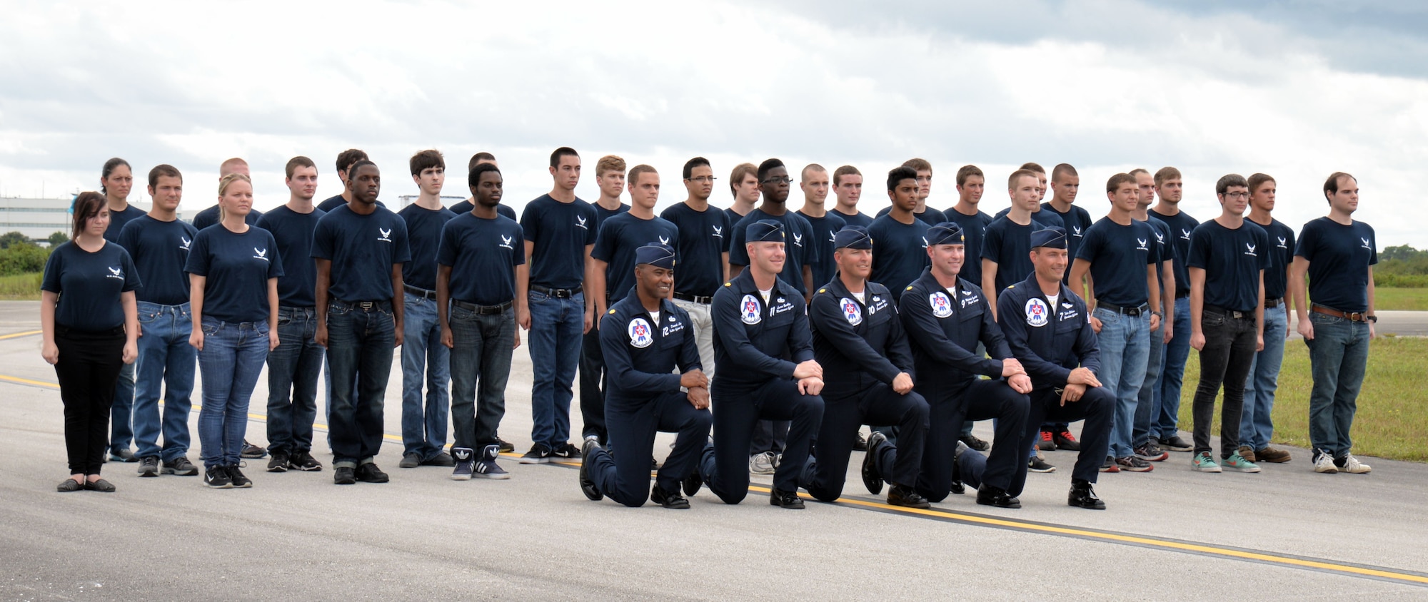 Thirty-one Air Force cadets stand with members of the U.S. Air Force Thunderbirds, after a swear in ceremony, Oct. 3, 2014, as part of events leading up to the Melbourne Air & Space Show, Melbourne, Fla. In attendance were friends and family who were invited by the Thunderbirds to watch their practice performance. (Courtesy Photo/Julian Leek/JNN)