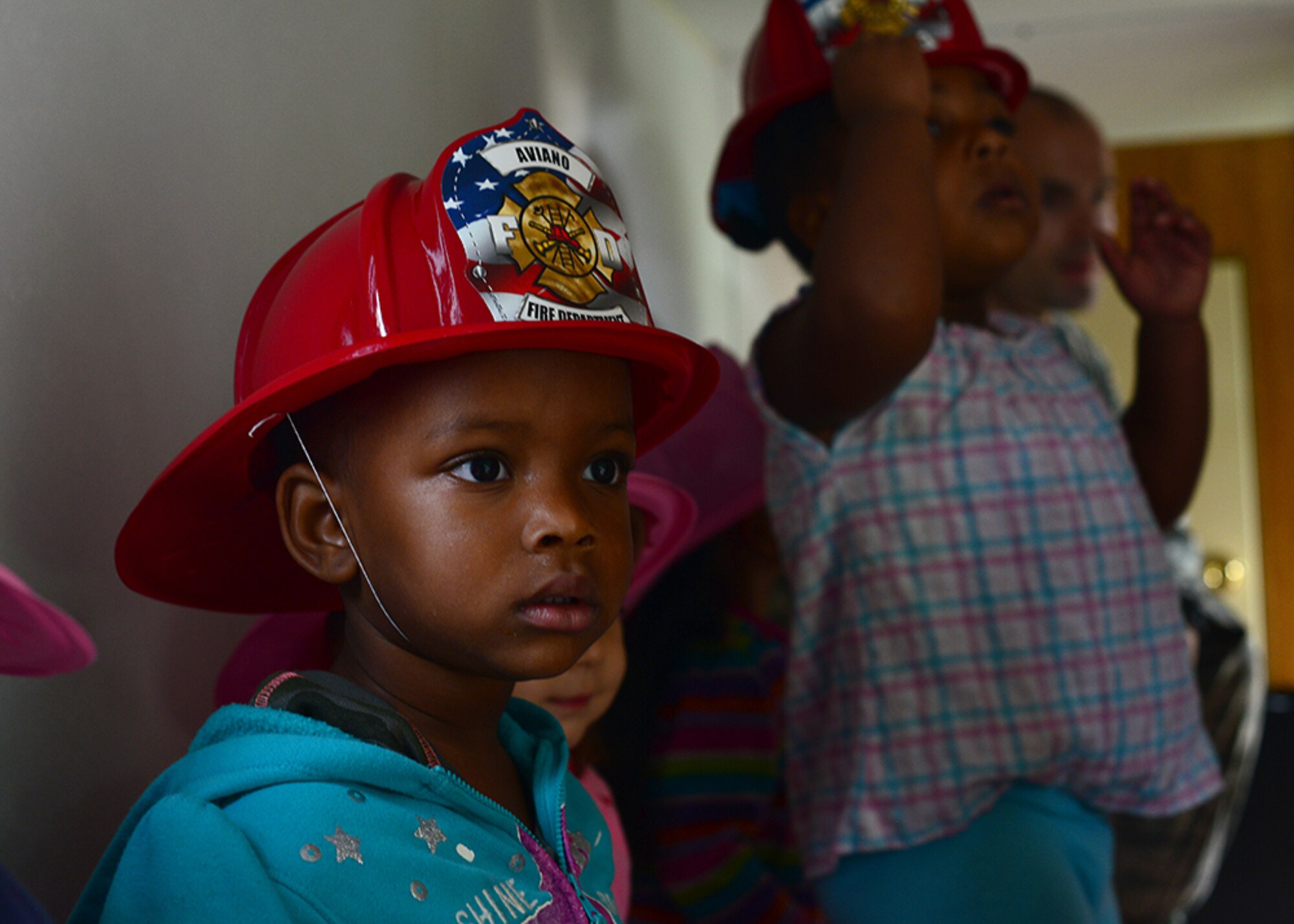 A child from the Aviano Child Development Center exits a smoke-filled room during a fire prevention week demonstration, Oct. 6, 2014, at Aviano Air Base, Italy. Following this year’s theme, "Smoke Alarms Save Lives: Test Yours Every Month!,” Aviano’s firefighters educated the base populace on the importance of maintaining their smoke alarms and testing them regularly. (U.S. Air Force photo/Senior Airman Michael Battles)