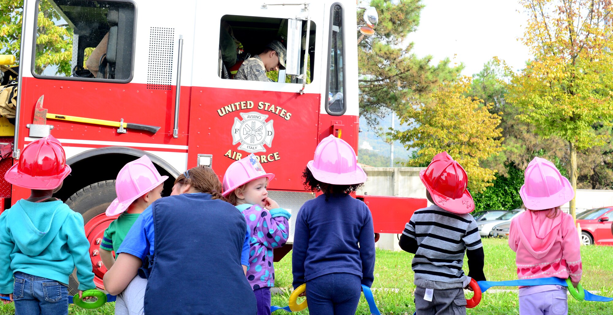 Children from the Aviano Child Development Center watch a fire truck demonstration during a fire prevention week school visit, Oct. 6, 2014, at Aviano Air Base, Italy. Following this year’s theme, "Smoke Alarms Save Lives: Test Yours Every Month!,” Aviano’s firefighters educated the base populace on the importance of maintaining their smoke alarms and testing them regularly. (U.S. Air Force photo/Senior Airman Michael Battles)