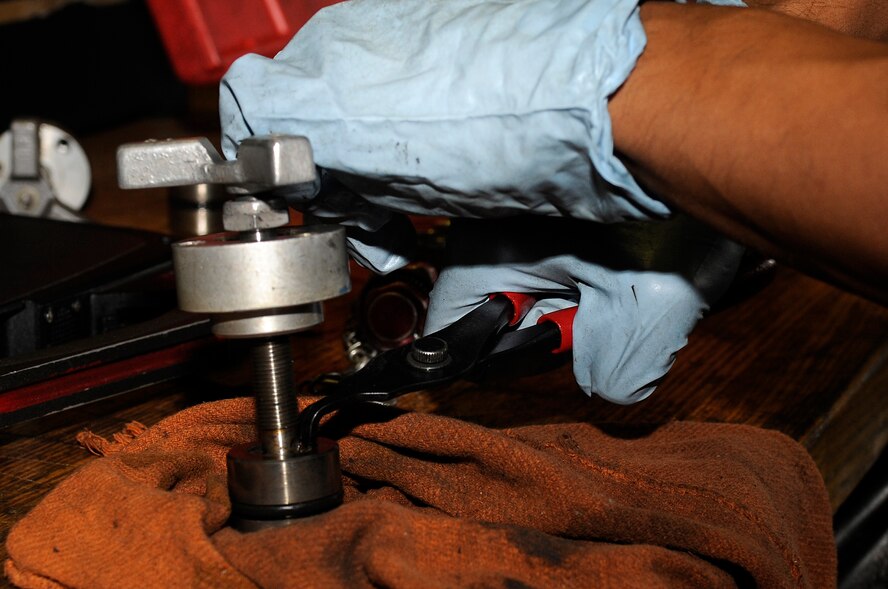 An aircraft ground equipment technician from the 18th Equipment Maintenance Squadron rebuilds a volume control valve for a hydraulic test stand on Kadena Air Base, Japan, Oct. 6, 2014. AGE technicians maintain and repair flightline equipment such as generator sets, hydraulic test stands, air compressors and bomb lifts. (U.S. Air Force photo by Senior Airman Marcus Morris/Released)