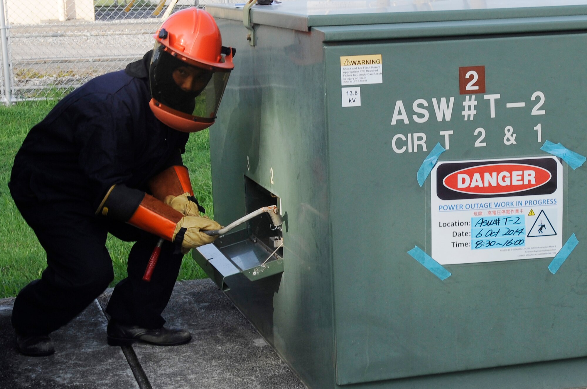 Taba Itsuji, 18th Civil Engineer Squadron electrician, shuts off power to overhead power lines that will be cut down on Kadena Air  Base, Japan, Oct. 6, 2014. The power was diverted to protect the contractors as well as keep the buildings on base operational. (U.S. Air Force photo by Senior Airman Marcus Morris/Released)