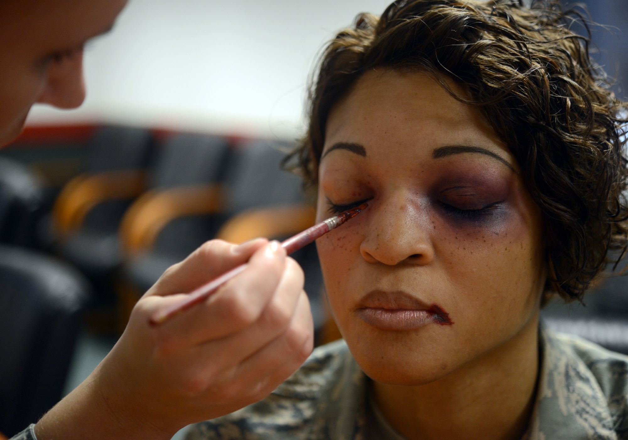 Senior Airman Liberty Provo, 86th Dental Squadron dental laboratory technician, applies makeup to Tech. Sgt. Erica Carr, 86th Communications Squadron Kaiserslautern Military Community frequency manager, to simulate domestic violence injuries at Ramstein Air Base, Germany, Oct. 2, 2014. October is Domestic Violence Awareness Month, and this year’s theme is “Thanks for Asking.” Participants volunteered to don the fake injuries to raise awareness for domestic violence victims, who sometimes remain silent. (U.S. Air Force photo/Senior Airman Timothy Moore)