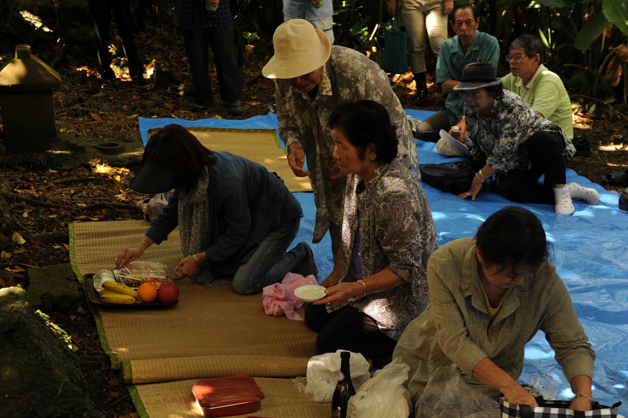 Okinawa City residents prepare food as offerings during Kikushu on Kadena Air Base, Japan, Oct. 2, 2014. Kikushu, which takes place each year on Sept. 9 of the lunar calendar, is an opportunity for residents of any given Japanese community to gather in a common area, such as a community garden, offer food to their ancestors and pray for their family's prosperity and a successful harvest. Afterward, a picnic is traditionally held where community members can share a meal with the spirits of their ancestors. (U.S. Air Force photo by Airman 1st Class Zade C. Vadnais/Released)
