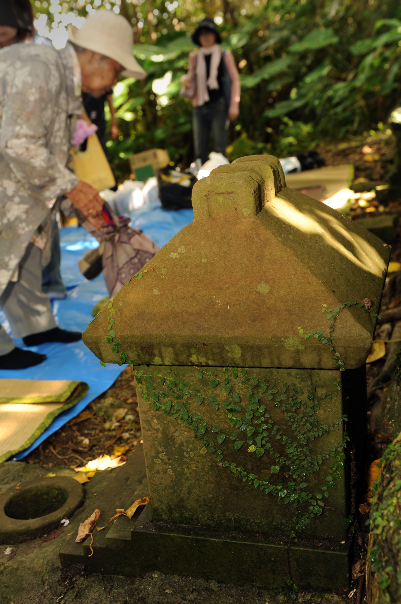 Residents from Okinawa City prepare for a picnic in celebration of Kikushu on Kadena Air Base, Japan, Oct. 2, 2014. Kikushu, a traditional Japanese celebration, takes place each year on Sept. 9 of the lunar calendar. This year, former residents of the land Kadena Air Base now occupies gathered in their old community garden to offer food to their ancestors and pray for the prosperity of their families and a successful harvest. (U.S. Air Force photo by Airman 1st Class Zade C. Vadnais/Released)