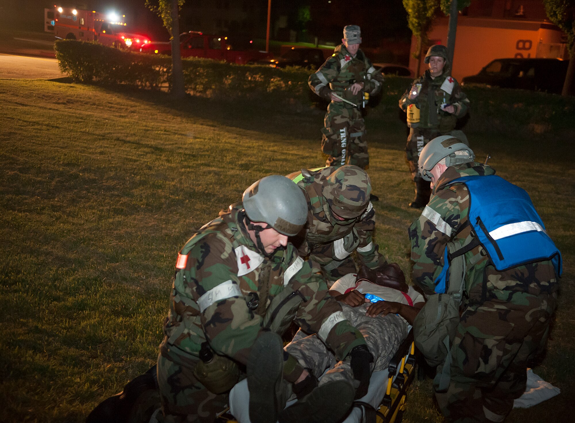 Wing inspection team members from the 51st Medical Group observe the procedures medics take during a mass casualty exercise at Osan Air Base, Republic of Korea, Sept. 17, 2014. WIT members are NCOs and officers who are recognized as elite members of their fields by their squadron commanders. (U.S. Air Force photo by Senior Airman Matthew Lancaster)