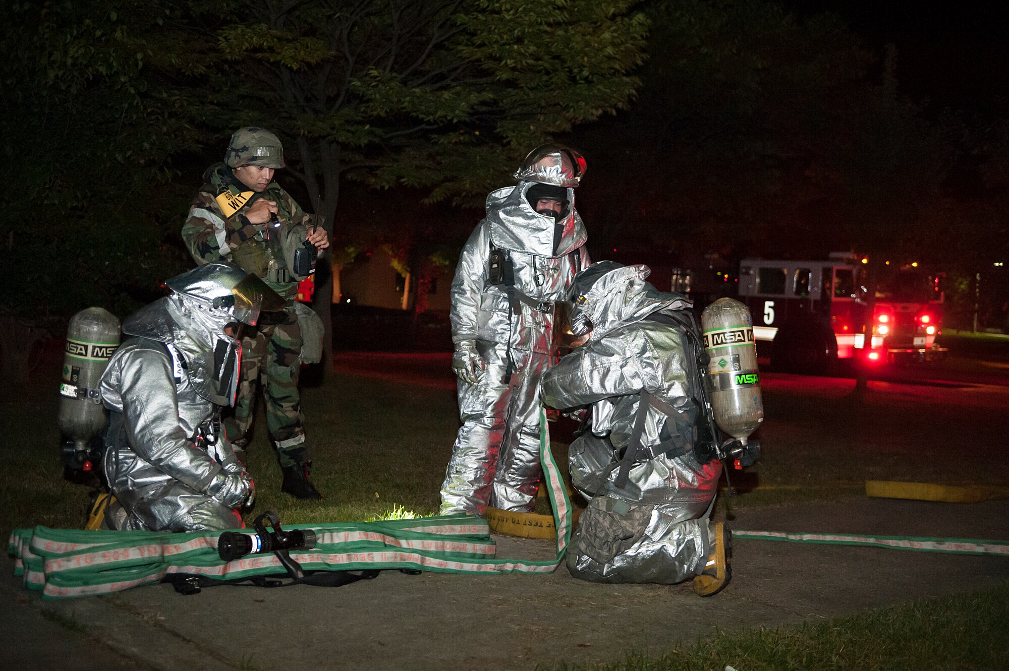 A wing inspection team member evaluates the performace of fire fighters from the 51st Civil Engineer Squadron during a mass casualty exercise at Osan Air Base, Republic of Korea, Sept. 17, 2014. The intent of the program is to inspect, document and educate Airmen on how to perform their jobs better in any scenario. (U.S. Air Force photo by Senior Airman Matthew Lancaster)