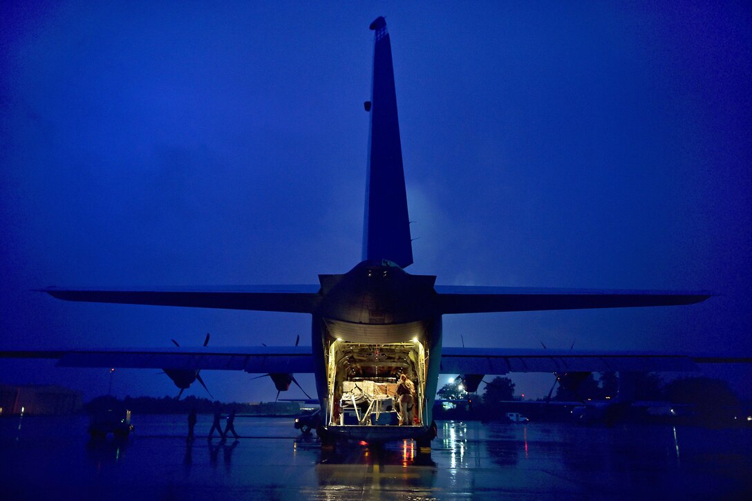 U.S. Air Force Staff Sgt. Cassandra Hancock prepares cargo on the ramp of a C-130-J Super Hercules aircraft on Ramstein Air Base, German, before a mission to help contain the Ebola outbreak in Liberia, Oct. 7, 2014. Hancock is a loadmaster assigned to the 37th Airlift Squadron.