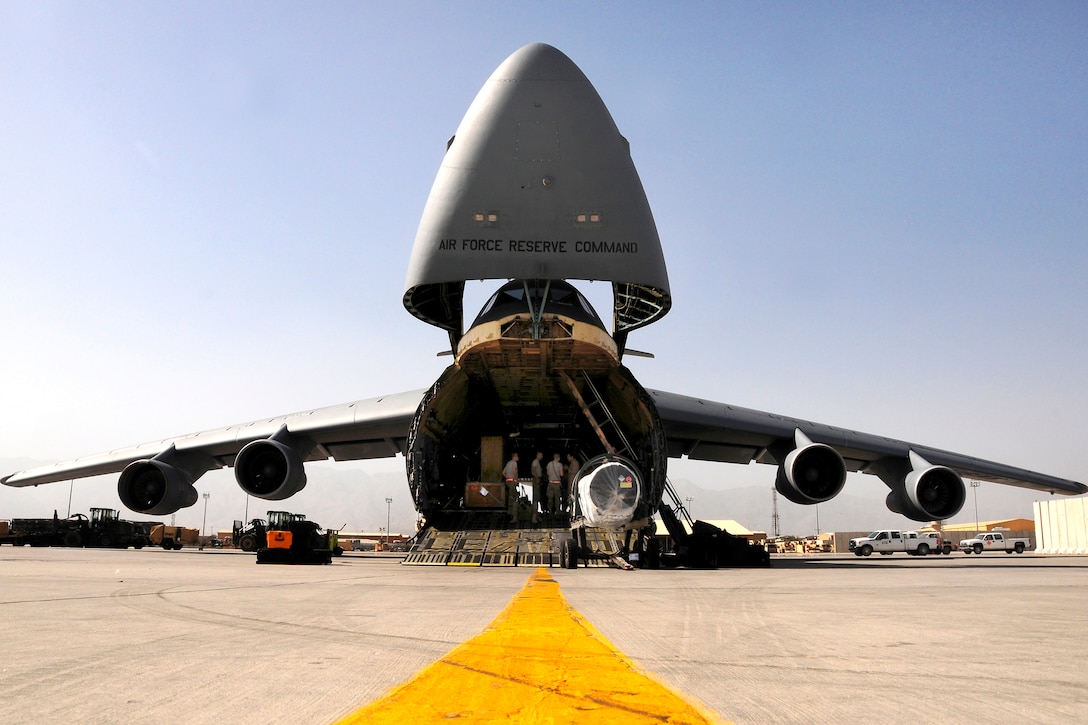 U.S. Air Force airmen prepare to load equipment onto a C-5 Galaxy ...