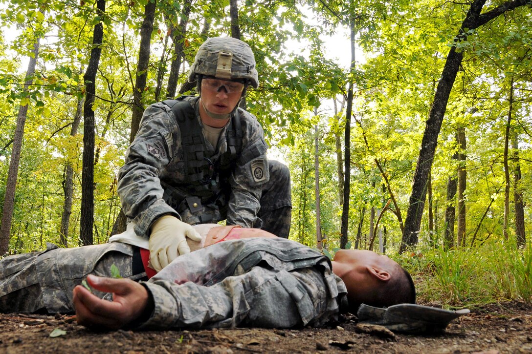 Army Pvt. Dylan Wilson tends to a simulated casualty during the combat testing lanes portion of the All-American Best Medic Competition on Fort Bragg, N.C., Oct. 7, 2014. Wilson is a medic assigned to the 82nd Airborne Division.