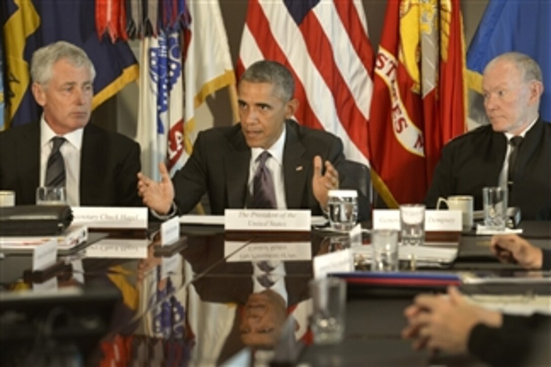 President Barack Obama addresses reporters after meeting with Defense Secretary Chuck Hagel, left, Army Gen. Martin E. Dempsey, chairman of the Joint Chiefs of Staff, and combatant commanders at the Pentagon, Oct. 8, 2014. 
