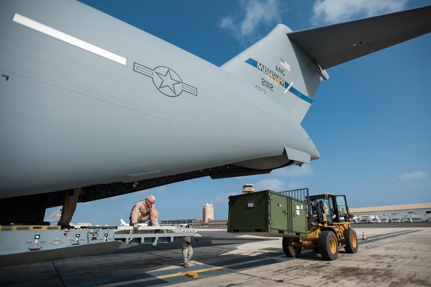 Aerial porters from the Kentucky Air National Guard’s 123rd Contingency Response Group off-load the unit’s gear from a Mississippi Air National Guard C-17 Globemaster III Oct. 4, 2014, at Léopold Sédar Senghor International Airport in Dakar, Senegal, in support of Operation United Assistance. More than 70 Kentucky ANG Airmen arrived with the gear to stand up an intermediate staging base at the airport that will funnel humanitarian supplies and equipment into West Africa as part of the international effort to fight Ebola. (U.S. Air National Guard photo/Maj. Dale Greer)