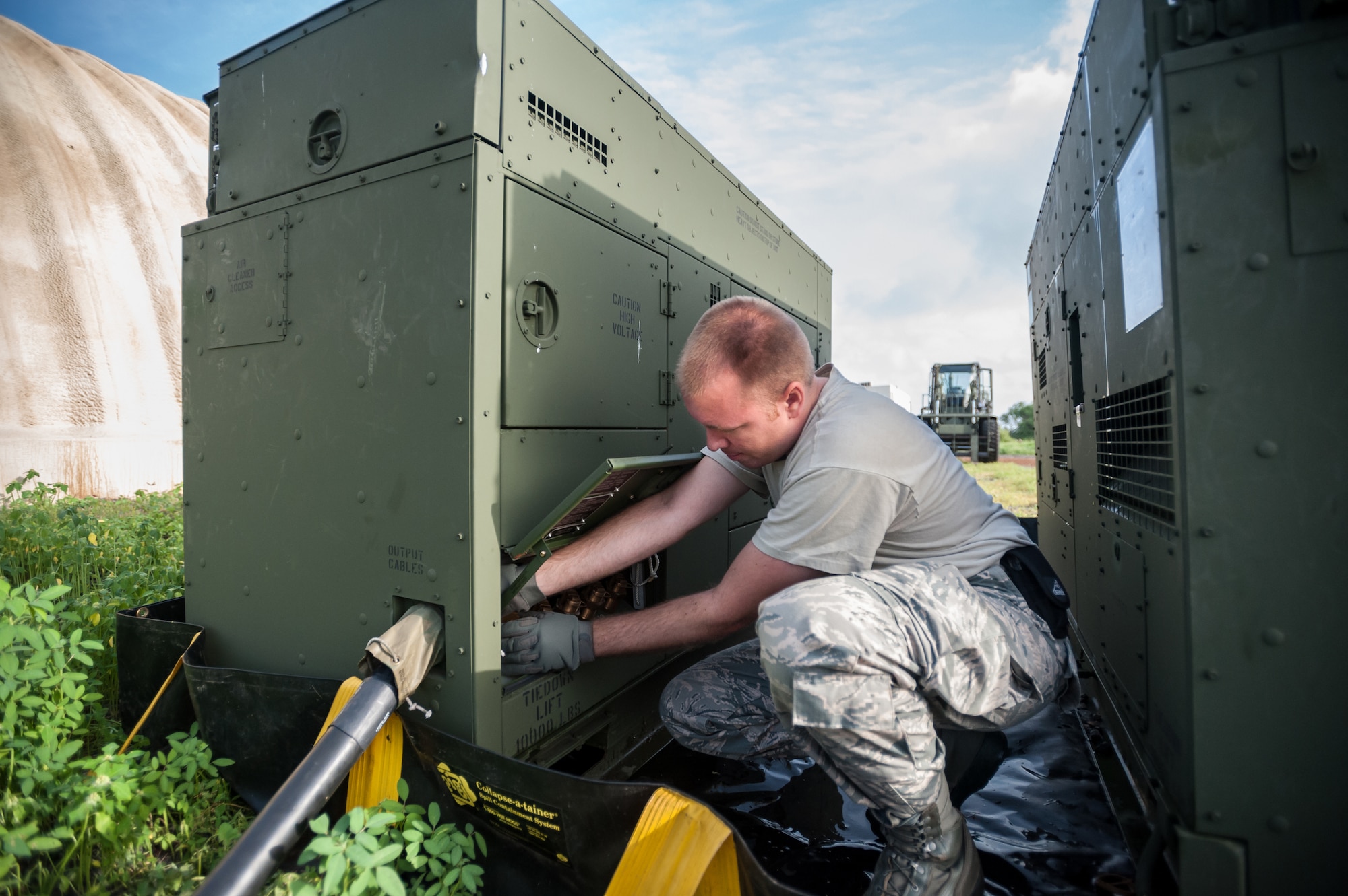 Senior Airman Courtnay Hester sets up an electric generator to feed the joint operations center Oct. 5, 2014, at Léopold Sédar Senghor International Airport in Dakar, Senegal, in support of Operation United Assistance. Hester and more than 80 other Airmen from the Kentucky Air National Guard stood up an intermediate staging base at the airport that will funnel humanitarian supplies and equipment into West Africa as part of the international effort to fight Ebola. Hester is a power production specialist with the Kentucky ANG’s 123rd Contingency Response Group. (U.S. Air National Guard photo/Maj. Dale Greer)