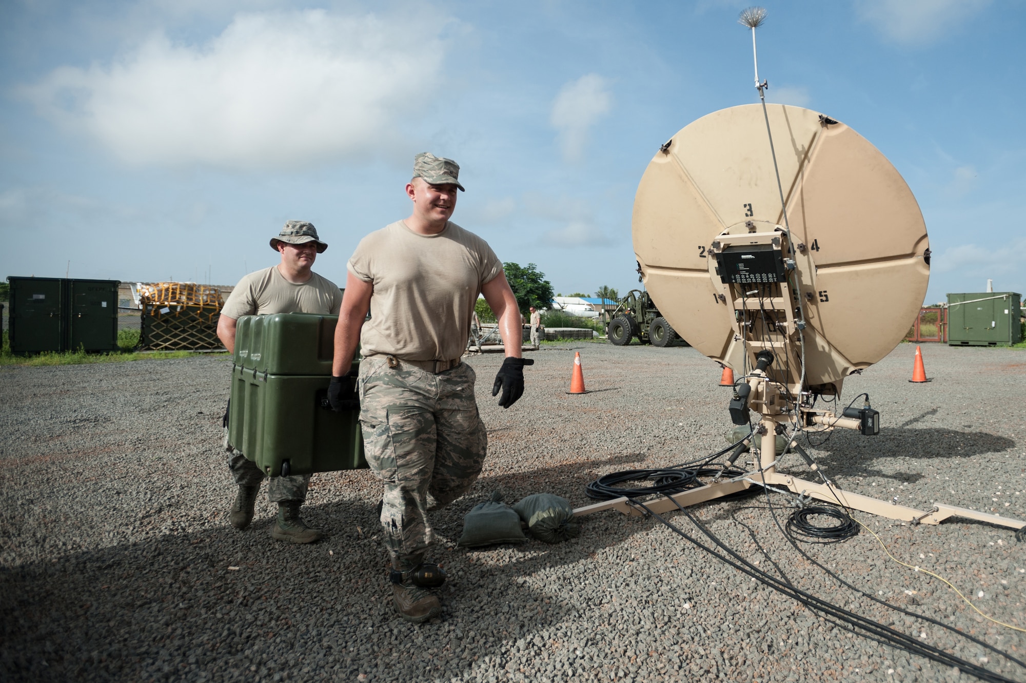 Staff Sgt. John May, left, and Senior Airman Alex Vincent carry equipment into the joint operations center Oct. 5, 2014, at Léopold Sédar Senghor International Airport in Dakar, Senegal, in support of Operation United Assistance. More than 80 Airmen from the Kentucky Air National Guard stood up an intermediate staging base at the airport that will funnel humanitarian supplies and equipment into West Africa as part of the international effort to fight Ebola. Both Airmen are members of the Kentucky ANG’s 123rd Contingency Response Group. (U.S. Air National Guard photo/Maj. Dale Greer)