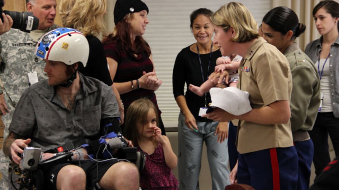 Captain Melanie Clifton, right, executive officer, Recruiting Station San Francisco, greets wounded warriors and their families during a visit to the Veterans Affairs Hospital in Palo Alto, Calif., Oct. 7. Marines and sailors spent time with wounded servicemembers and imparted them with words of support and enthusiasm. The visit was held during San Francisco Fleet Week 2014, which focuses on interoperability training between civil and military agencies to improve cooperation and coordination, as well as increase readiness through a range of humanitarian assistance operations.