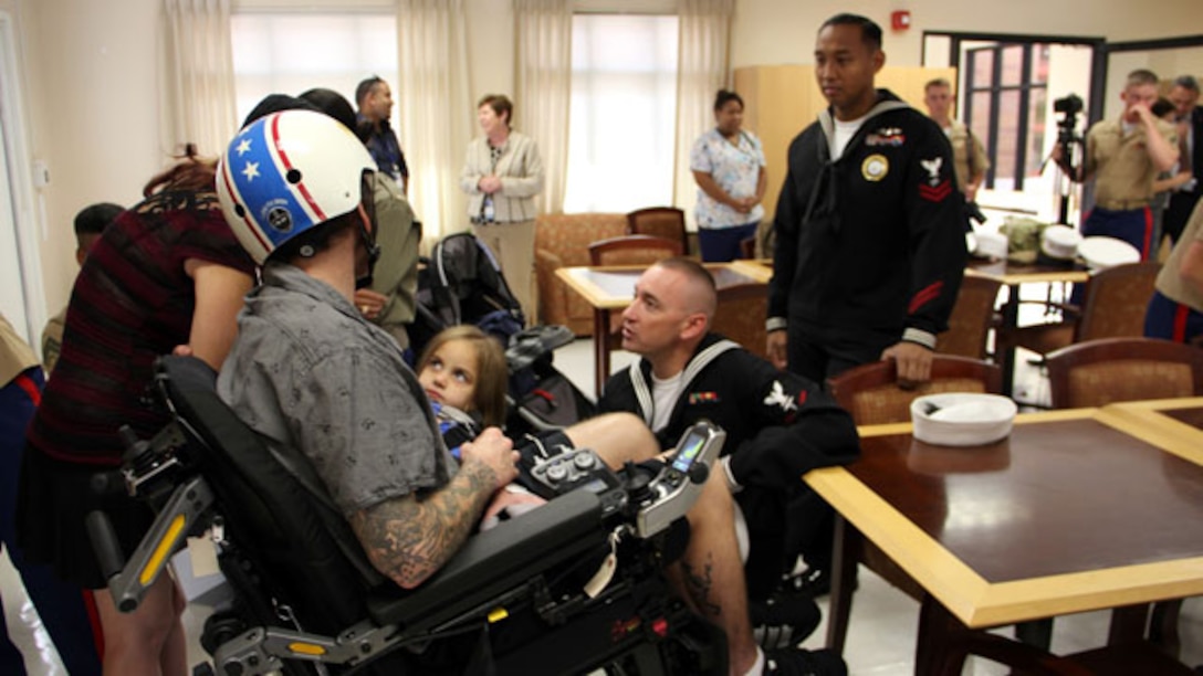Sailors with Navy Recruiting Command San Francisco spend time with wounded warriors and their families during a visit to the Veterans Affairs Hospital in Palo Alto, Calif., Oct. 7. Marines and sailors spent time with wounded servicemembers and imparted them with words of support and enthusiasm. The visit was held during San Francisco Fleet Week 2014, which focuses on interoperability training between civil and military agencies to improve cooperation and coordination, as well as increase readiness through a range of humanitarian assistance operations.