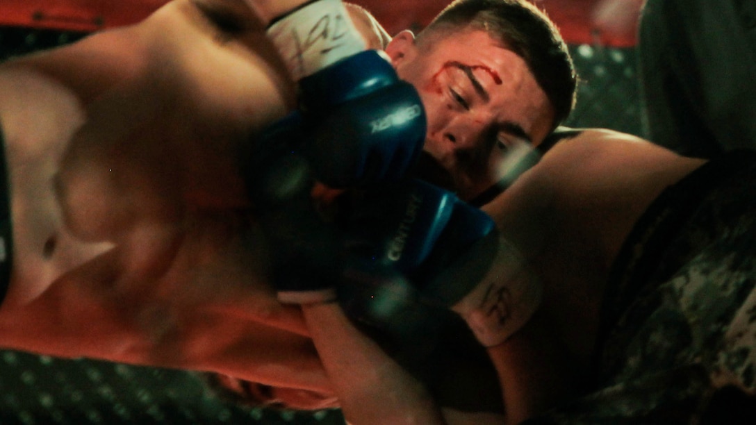 John Zimmer, a security specialist at Headquarters Battalion, Marine Forces Reserve, tries to fight off his opponent’s take down at the Caged Warrior Championship V on Oct. 4, 2014, in Patterson, La. This was Zimmer’s first time competing in a mixed martial arts fight. Although he lost, Zimmer looks forward to future challenges as a martial artist. 