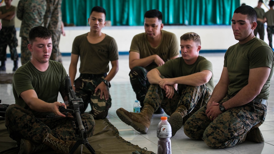 U.S. Marine Lance Cpl. Taylon C. Sherrill demonstrates disassembling the M240B medium machine gun to Philippine airmen and U.S. Marines Oct. 3 at Basa Air Base, Philippines. The service members shared best practices in training areas, including weapons handling, airbase ground defense, and jungle warfare tactics as part of a training event taking place during Amphibious Landing Exercise 2015. PHIBLEX 15 is an annual, bilateral training event conducted to improve interoperability and strengthen the bond between the Philippines and U.S. The U.S. Marines are with Marine Wing Support Squadron 172, Marine Air Group 36, 1st Marine Aircraft Wing. The Philippine airmen are with the Air Defense Wing.