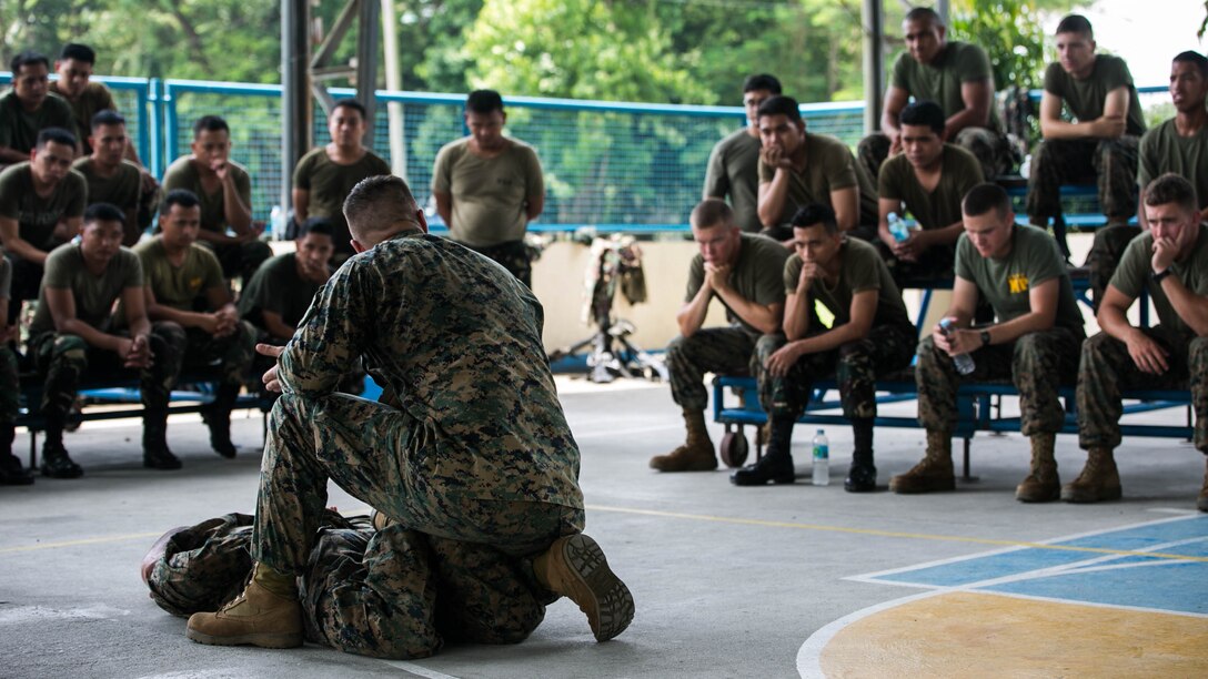U.S. Marine GySgt. Karl L. Park demonstrates proper techniques for handling a detainee to Philippine airmen and U.S. Marines Oct. 3 at Basa Air Base, Philippines. The service members shared best practices in training areas, including weapons handling, airbase ground defense, and jungle warfare tactics as part of a training event taking place during Amphibious Landing Exercise 2015. PHIBLEX 15 is an annual, bilateral training event conducted to improve interoperability and strengthen the bond between the Philippines and U.S. The U.S. Marines are with Marine Wing Support Squadron 172, Marine Air Group 36, 1st Marine Aircraft Wing. The Philippine airmen are with the Air Defense Wing. 