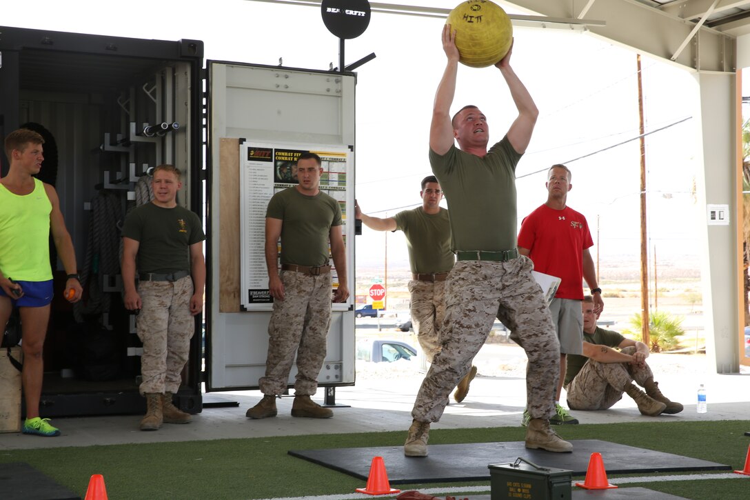 Sgt. David Long, Marine Wing Support Squadron 374, lifts a 90-pound medicine ball as part of the overhead lift challenge of the Warrior Games, at the West Gym aboard the Combat Center Oct. 7, 2014. The overhead lifts were part of the final event on the first day of the games.