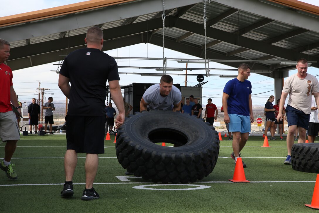Sgt. Michael Goeas, Marine Wing Support Squadron 374, conducts tire flips during the Warrior Games at the West Gym aboard the Combat Center Oct. 7, 2014. The tire flips were part of a strength gauntlet, the first of five events for the first day of the games.