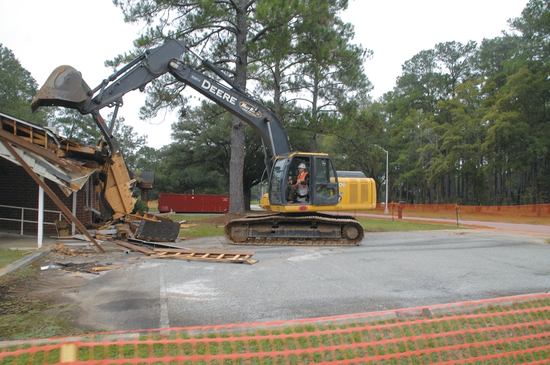 Marine Corps Logistics Base Albany officials participate in the demolition of 9201 Williams Blvd., Sept. 25. Built in 1957, the building served as the family housing and billeting office. According to base officials, the structure is considered excess inventory and the area will be returned to its natural state — grass.