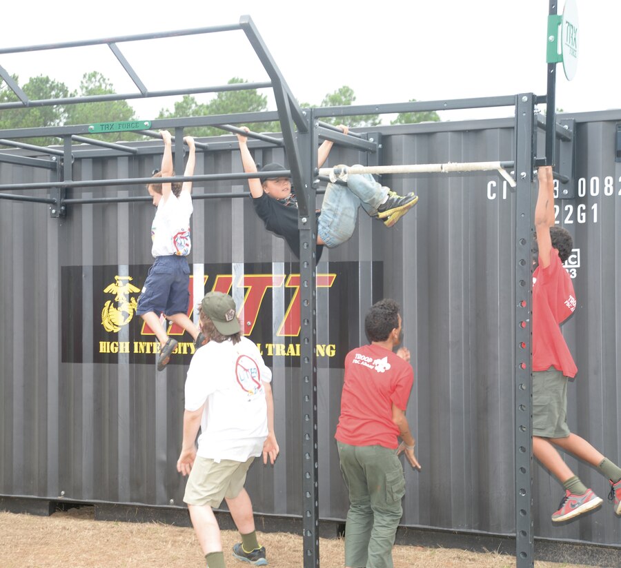 Boy Scouts hang from the monkey bars during their recent annual camporee. It was part of high intensity tactical training facilitated by Marines at Marine Corps Logistics Base Albany.