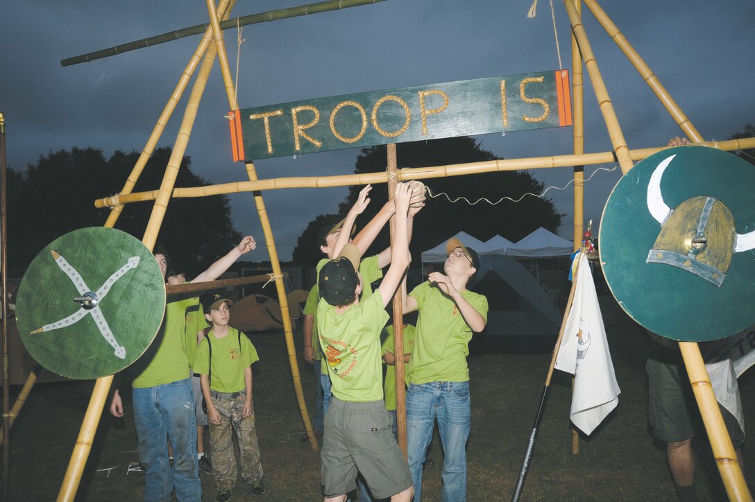 Boy Scouts from Troop 15 mount their unit's sign on a bamboo stand during the scouts' camporee held recently at Marine Corps Logistics Base Albany's Boyett Park.