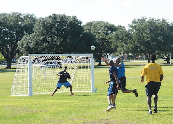 Navy Branch Health Clinic's corpsman, Petty Officer 3rd Class Mario Fuller, guards the goal during a handball game at Marine Corps Logistics Base Albany's Boyett Park, recently. Fuller was the goalie for his team, who participated in a recent Fun Day challenge against fellow shipmates in their physical fitness competition on the base’s soccer field.