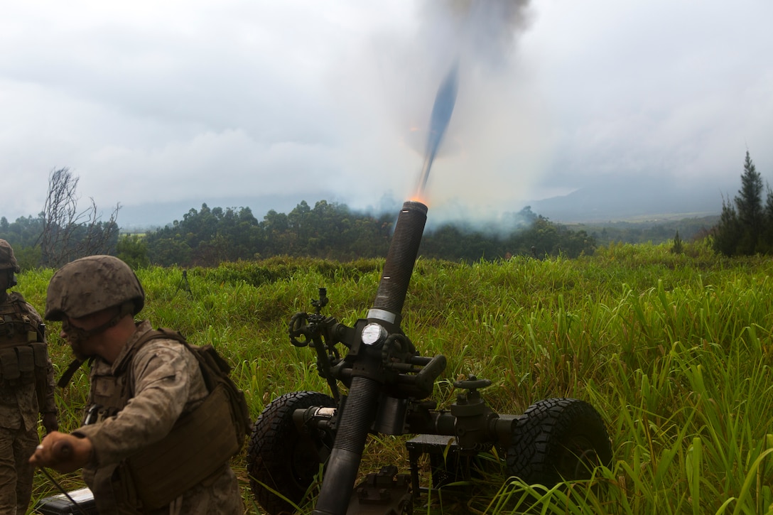 SCHOFIELD BARRACKS, Hawaii – Cpl. Robert Modar, a cannoneer with Charlie Battery, 1st Battalion, 12th Marine Regiment, pulls the lanyard on an M327 Expeditionary Fire Support System Oct. 7 during a training and readiness evaluation. The Marines from 1st Bn., 12th Marines, were getting evaluated on timeliness of getting the 120 mm rounds fired off as preparation for an upcoming deployment. (U.S. Marine Corps photo by Cpl. Erik Estrada)