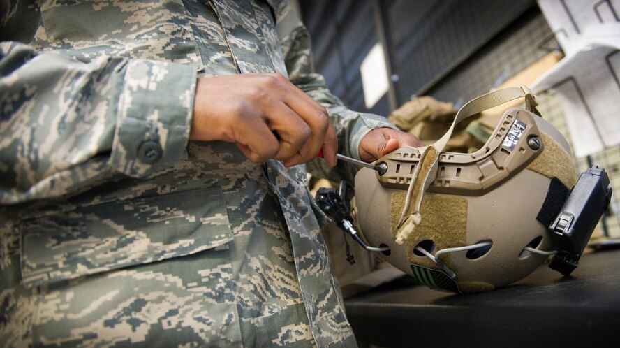 Staff Sgt. Keenan Murray, 34th Special Operations Squadron aircrew flight equipment craftsman, works on a helmet at the 1st Special Operations Group Detachment 1 building on Hurlburt Field, Fla., Oct. 7, 2014. AFE Airmen are responsible for ensuring all emergency safety equipment like parachutes and survival kits are ready to go should they be needed. (U.S. Air Force photo/Senior Airman Krystal M. Garrett)