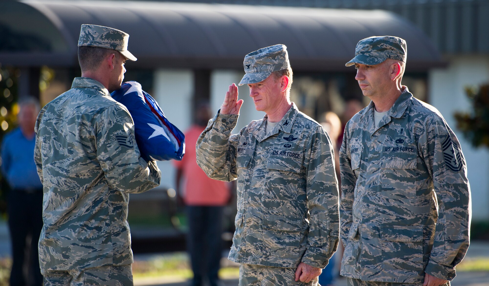 Col. Bill West, 1st Special Operations Wing commander, salutes the United States Flag during a retreat ceremony at Hurlburt Field, Fla., Oct. 8, 2014. The 1st SOW Wing Staff Agencies such as public affairs, legal, safety and finance conducted the retreat ceremony.  (U.S. Air Force photo/Senior Airman Krystal M. Garrett)