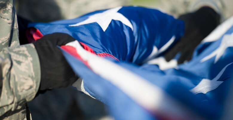 Airmen from the 1st Special Operations Wing Honor Guard fold the United States Flag during retreat ceremony at Hurlburt Field, Fla., Oct. 8, 2014. By giving the flag a distinctive fold, it shows respect to the flag and expresses gratitude to individuals who fought and continue to fight for freedom. (U.S. Air Force photo/Senior Airman Krystal M. Garrett) 