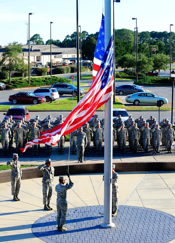 Members of wing staff agencies and members of the Honor Guard conduct a retreat ceremony at the wing headquarters building at on Hurlburt Field, Fla., Oct. 8, 2014. Airmen have performed retreat ceremonies at the end of every official duty day since 1947, the birth year of the Air Force. (U.S. Air Force photo/Airman 1st Class Andrea Posey)