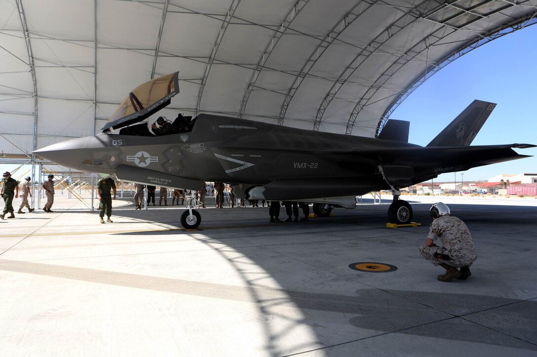 A F-35B Lightning II with Marine Operational and Test Evaluation Squadron (VMX) 22 sits under a canopy while Marines conduct post flight checks aboard Edwards Air Force Base, Calif., Oct. 9. The F-35 Lightning II is scheduled to replace several Marine aircraft in the future.