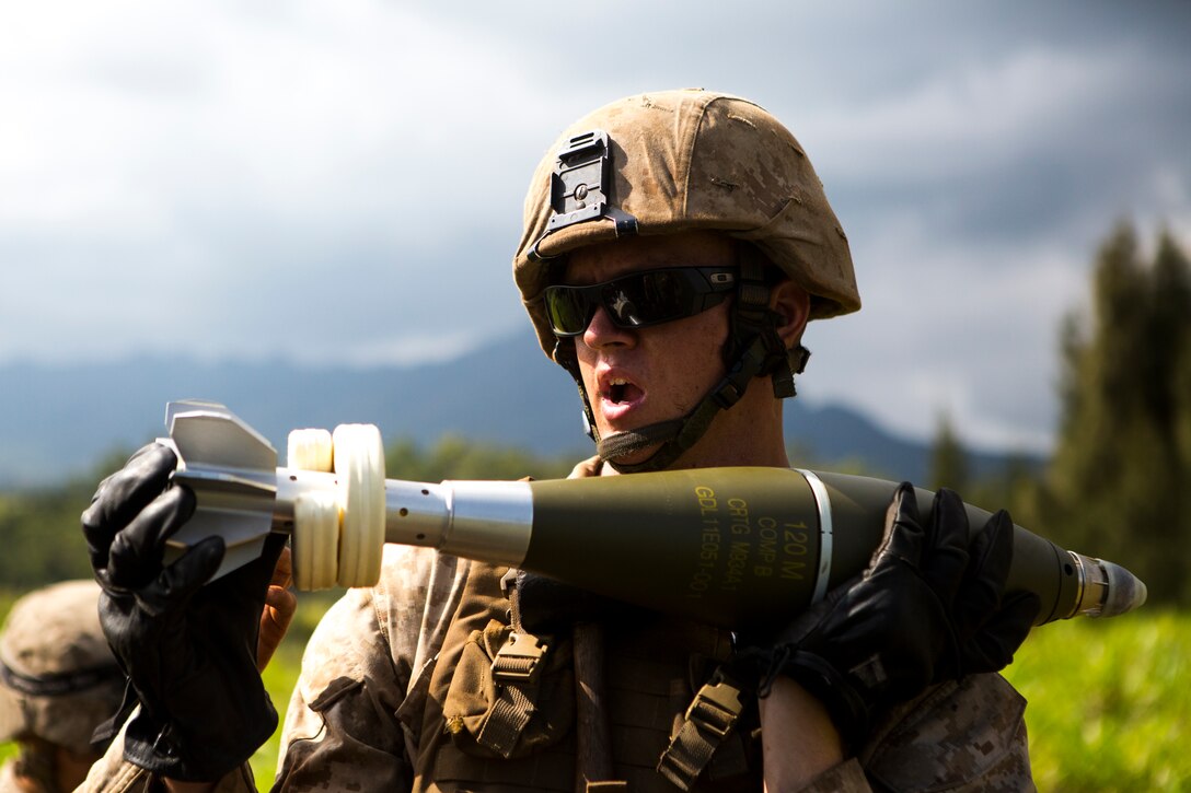 Lance Cpl. Dylan Johnson, a cannon crewman with Charlie Battery, 1st Battalion, 12th Marine Regiment, preps a 120 mm high explosive round prior to it being fired from a M327 Expeditionary Fire Support System Oct. 7 during a training and readiness evaluation. The artillerymen from 1st Bn., 12th Marines, spent two days out on the range for their final evaluation prior to leaving to Okinawa. 