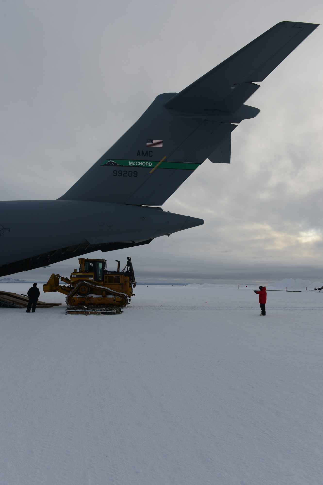 A Caterpillar D-8 bulldozer starts its upload to the back of the McChord Field C-17 Globemaster III aircraft, Oct. 8th, 2014 at the Pegasus White Ice runway, part of McMurdo Station, Antarctica. The bulldozer weighed in at approximately 75,000 pounds and put the maximum cargo weight of the C-17 to its limits. (U.S. Air Force photo/Master Sgt. Todd Wivell)