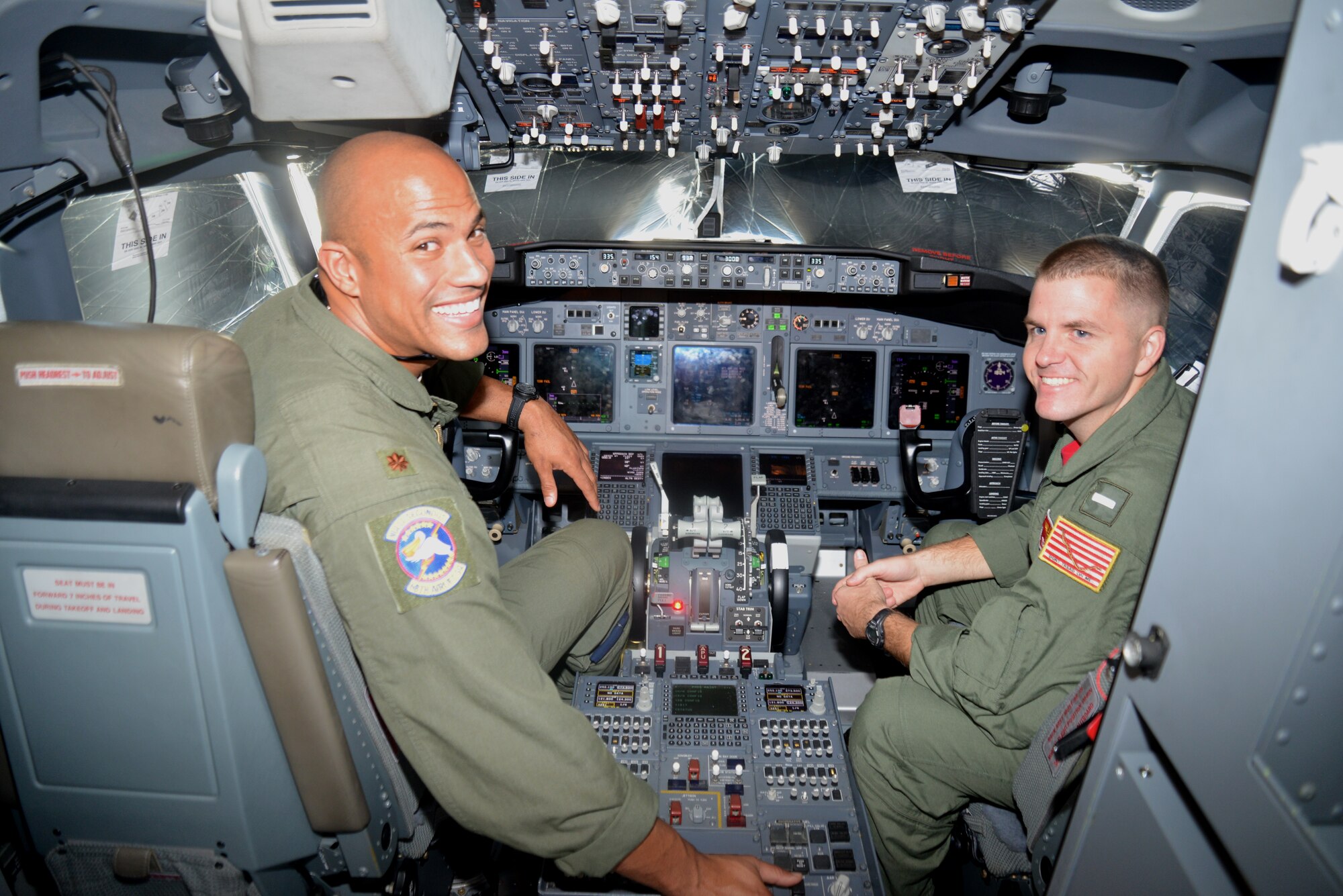 C-5A Pilot Major Chris Jones (left) 68th Airlift Squadron, Joint Base San Antonio, Texas and Lt. j.g. Eric Scott pilot, Navy Air Station Jacksonville, Florida in the cockpit of a P-8A Poseidon, during the Navy’s visit the Alamo Wing, Oct.3, 2014.  The Navy P-8A aircraft is a militarized Boeing 737, used for maritime patrol and Anti-Submarine Warfare. (U.S. Air Force photo by Minnie Jones)