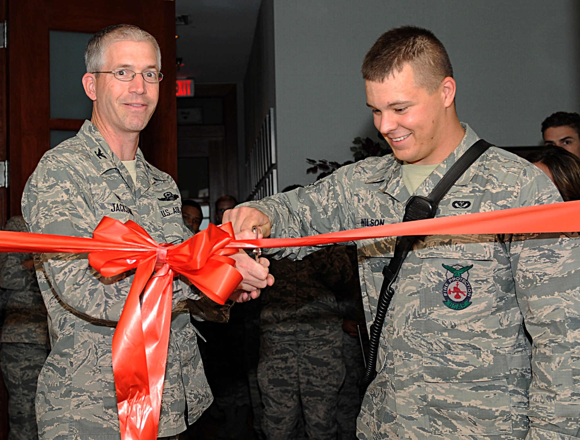 Col. Joel Jackson, 22nd Air Refueling Wing commander, cuts the ceremonial ribbon during The Breakaway’s Grand Opening, Oct. 9, 2014, at McConnell Air Force Base, Kan. The center provides junior enlisted Airmen with a place to use as a reprieve from work, where they can relax and network with other Airmen from around base. (U.S. Air Force photo/Airman 1st Class David Bernal Del Agua)