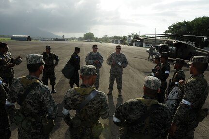 A U.S. Army aviation crew briefs flight safety to Honduran service members October 6 before boarding a UH-60 Blackhawk during Operation Caravana.  Operation Caravana’s sole purpose is to provide the Honduran military freedom of movement and access to the isolated areas in Gracias a Dios, Colon and Olancho in order to continue their security operations.  These troop movements and logistics re-supply flights will occur on an as-needed basis.  (Photo by U.S. Air National Guard Capt. Steven Stubbs)