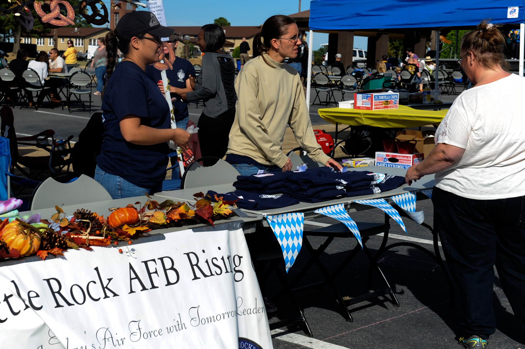 Members of the Rising Six council solicit wares to attendees during Rocktoberfest Oct. 4, 2014, at Little Rock Air Force Base, Ark. Approximately 60 booths showed up for Rocktoberfest. (U.S. Air Force photo by Staff Sgt. Jessica Condit)