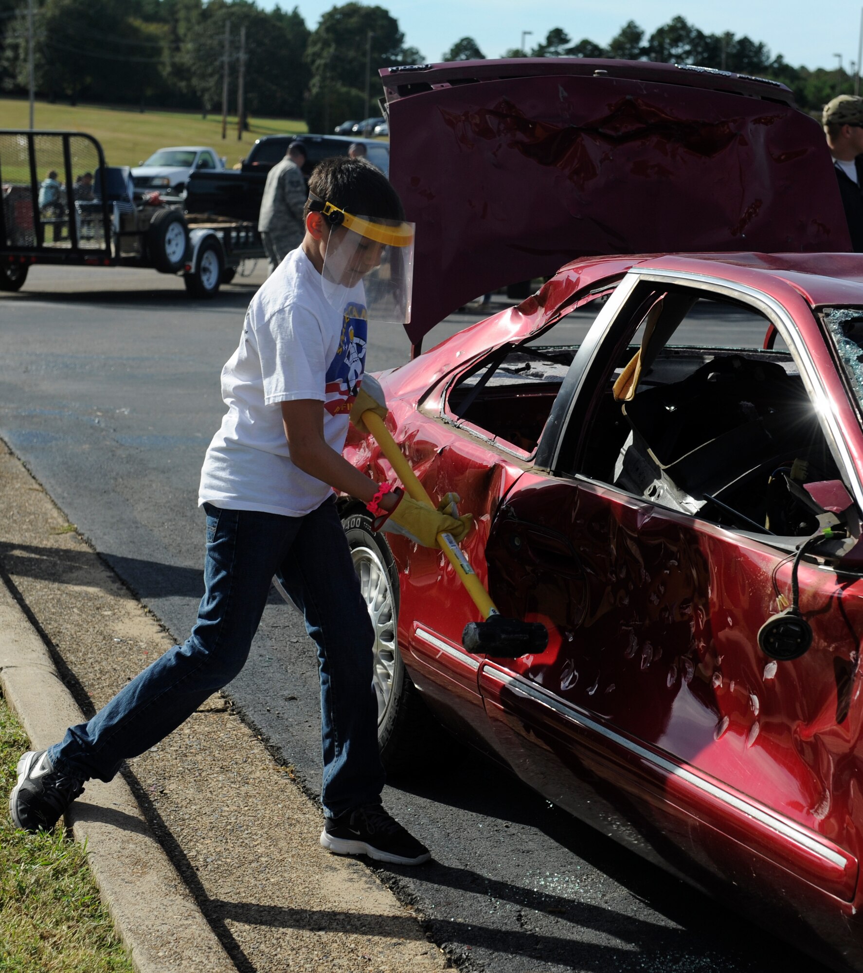 A child takes his turn at the car smashing booth, hosted by the 19th Maintenance Squadron, Oct. 4, 2014, at Little Rock Air Force Base, Ark. Rocktoberfest consisted of approximately 60  booster club, outside sponsor and regular vendor booths. (U.S. Air Force photo by Staff Sgt. Jessica Condit)