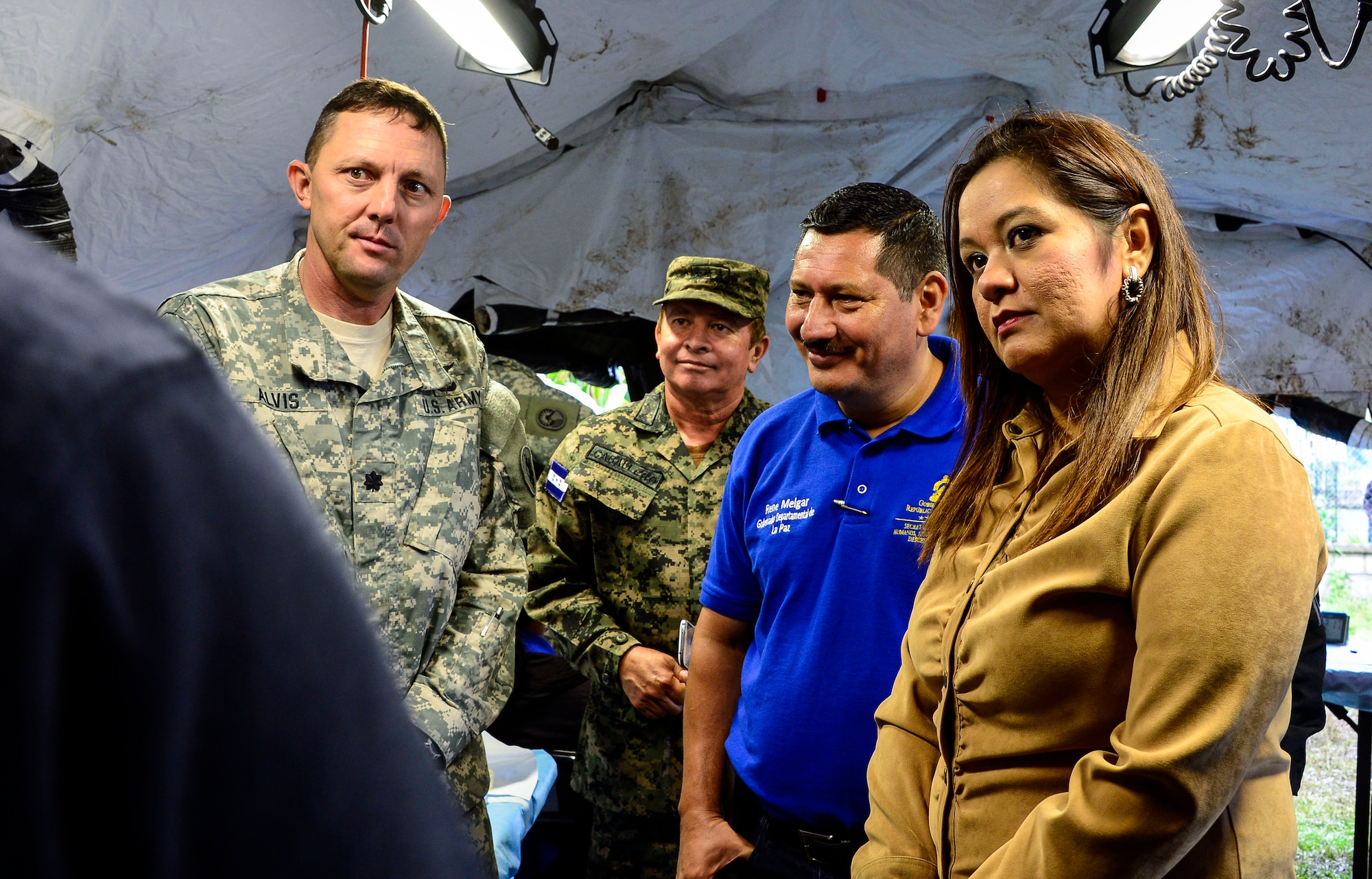 U.S. Army Lt. Col. Michael Alvis, deputy commander of the Medical Element; Rene Melgar, governor of La Paz; and Yanitza Rodriguez, representative from the La Paz Ministry of Human Rights are shown the mobile dental clinic as part of the Medical Readiness and Training Exercise site tour in San Marco, La Paz, Honduras, Oct. 8, 2014. The MEDRETE provided the citizens of San Marco an opportunity to receive basic medical care as well as providing the military members with the opportunity to train in a remote location. (U.S. Air Force photo by Tech. Sgt. Heather Redman/Released)
