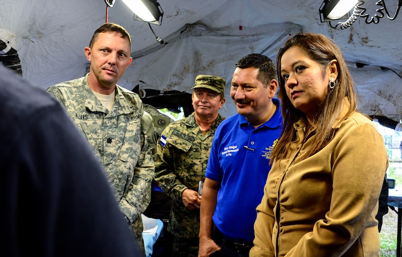 U.S. Army Lt. Col. Michael Alvis, deputy commander of the Medical Element; Rene Melgar, governor of La Paz; and Yanitza Rodriguez, representative from the La Paz Ministry of Human Rights are shown the mobile dental clinic as part of the Medical Readiness and Training Exercise site tour in San Marco, La Paz, Honduras, Oct. 8, 2014. The MEDRETE provided the citizens of San Marco an opportunity to receive basic medical care as well as providing the military members with the opportunity to train in a remote location. (U.S. Air Force photo by Tech. Sgt. Heather Redman/Released)
