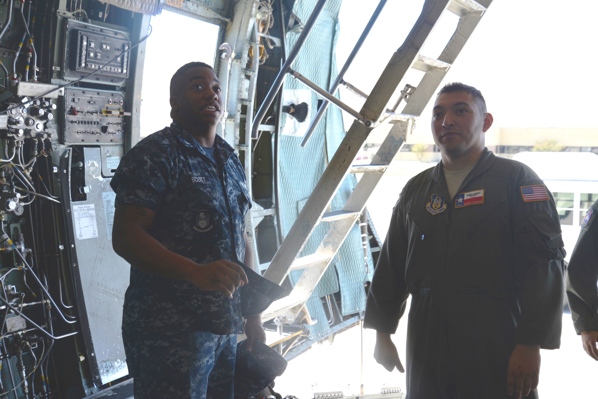 Staff Sgt. Anthony Sandoval (right) C-5A flight engineer, 68th Airlift Squadron gives a tour of the C-5A Galaxy to Aviation Electrician Mate, Petty Officer First Class, Eric Scott during the Navy’s visit to the 433rd Airlift Wing, Joint Base San Antonio-Lackland, Texas Oct. 3, 2014. (U.S. Air Force photo by Minnie Jones)