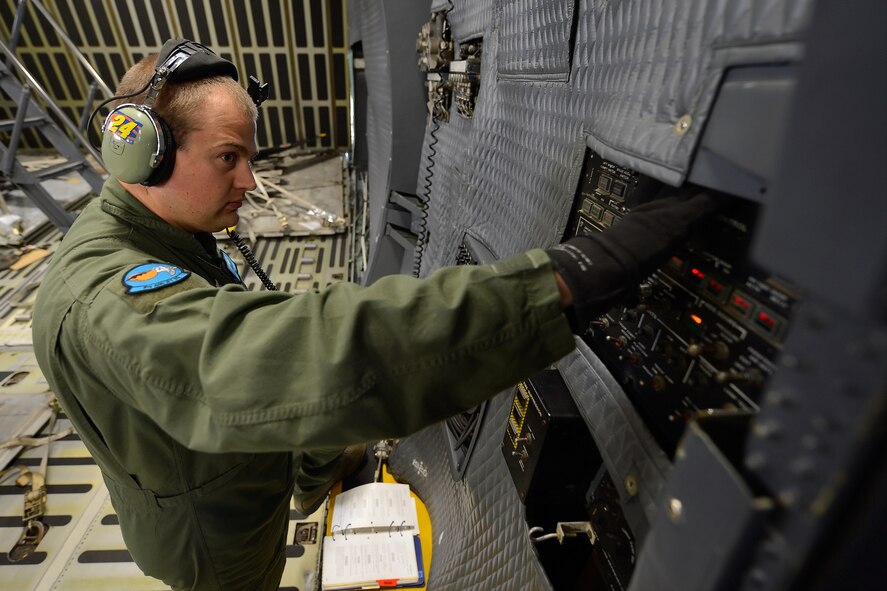 Tech. Sgt. Chris Clark, a C-5M Super Galaxy loadmaster, waits for a light to illuminate on the aft ramp and doors control panel of a C-5M Super Galaxy Oct. 5, 2014, at Dover Air Force Base, Del. Clark is assigned to the 9th Airlift Squadron, 436th Airlift Wing. (U.S. Air Force photo/Greg L. Davis)