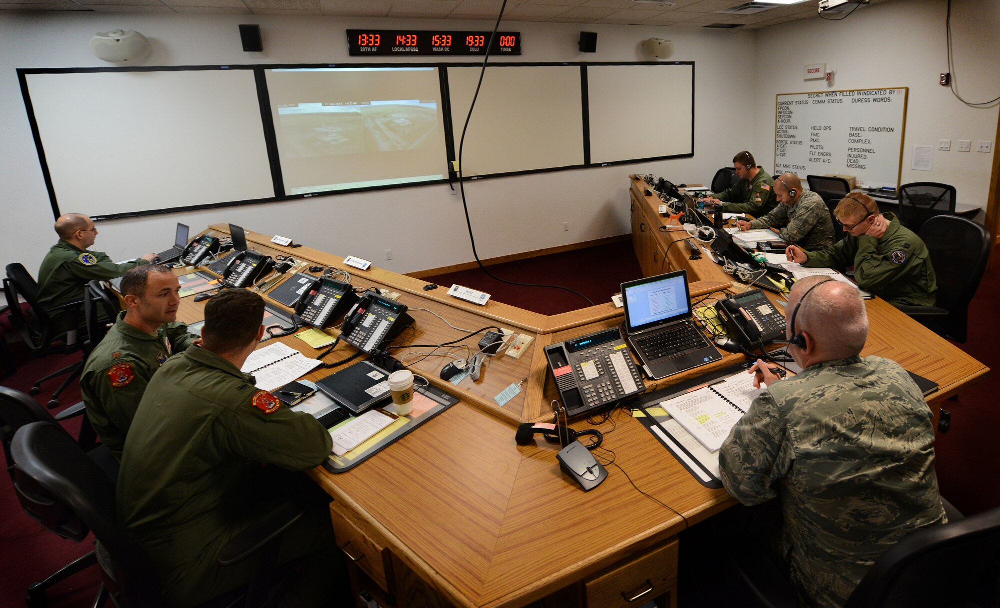 Members from the 91st Missile Wing and Vandenberg Air Force Base are briefed after participating in the simulated electronic launch of the Minuteman III missile test on Minot AFB, N.D., Sept. 11, 2014. The SELM is a team effort that includes missile maintainers, operators and defenders to ensure the simulated launch is executed properly. (U.S. Air Force photo by Airman 1st Class Lauren Pitts)
