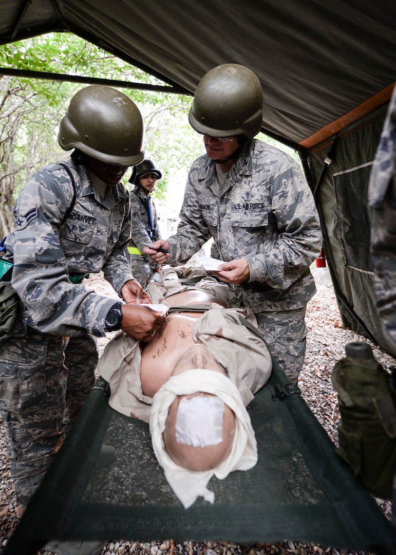 Airmen from the 59th Medical Wing perform triage during the deployment readiness training exercise at Joint Base San Antonio-Lackland, Texas, July 25. DRT is a 2-day mandatory training required biennially or prior to deployments. (U.S. Air Force photo/Staff Sgt. Kevin Iinuma)