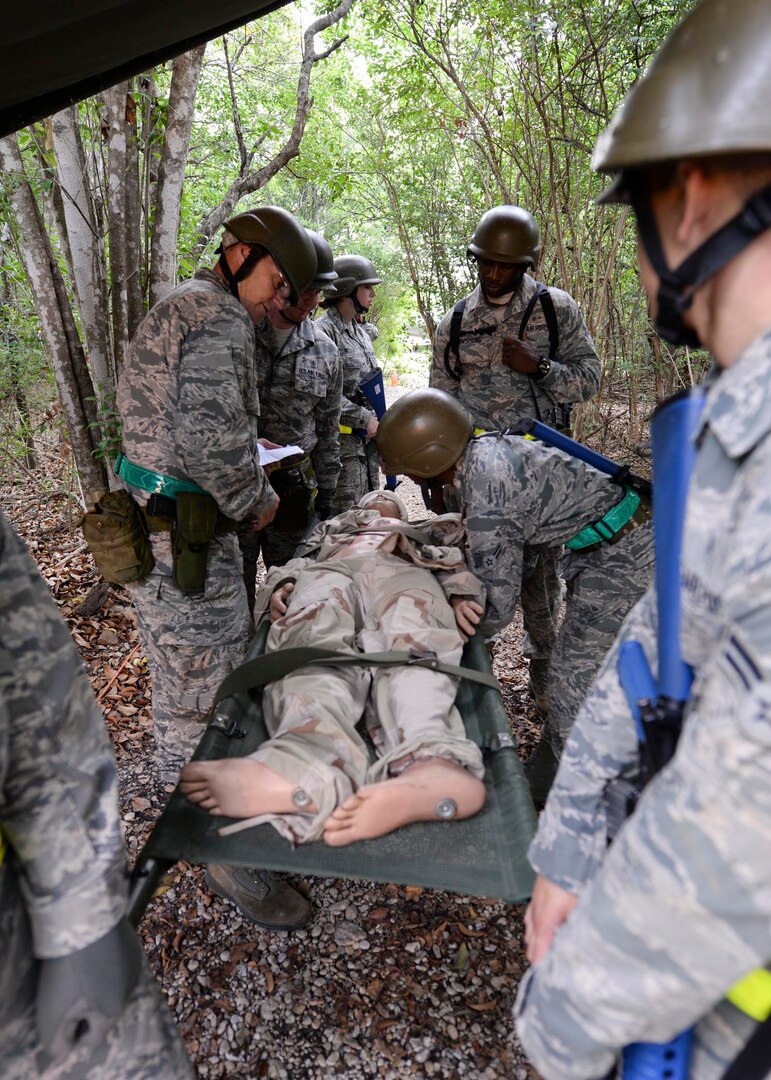 Military members from 59th Medical Wing perform triage during the deployment readiness training exercise at Joint Base San Antonio-Lackland, Texas, July 25. DRT is a 2-day mandatory training required biennially or prior to deployments. (U.S. Air Force photo/Staff Sgt. Kevin Iinuma)